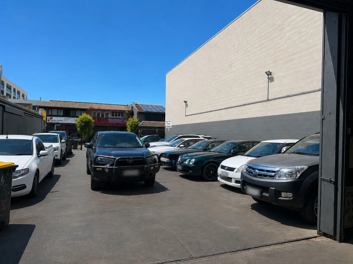 Customer cars parked outside the workshop on Byron Place